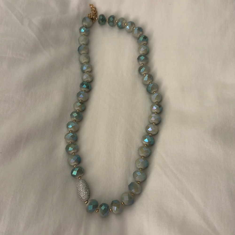 Green irrediscent beads with adjustable table clasp pave disc on bottom of neck